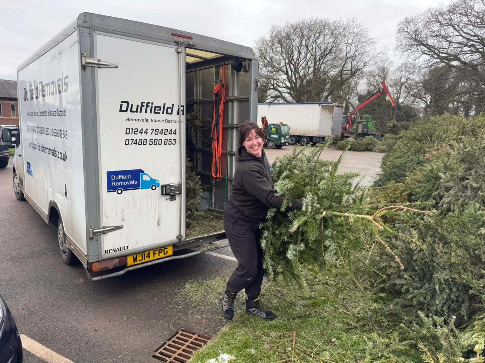 Leanne from Duffield Removals unloading collected Christmas trees