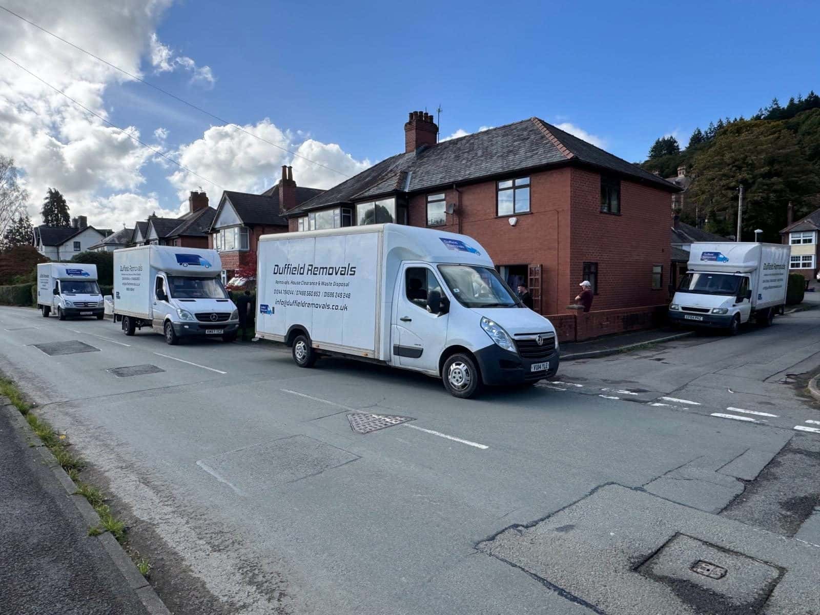 Four Duffield Removals vans outside a red-brick semi on one house move