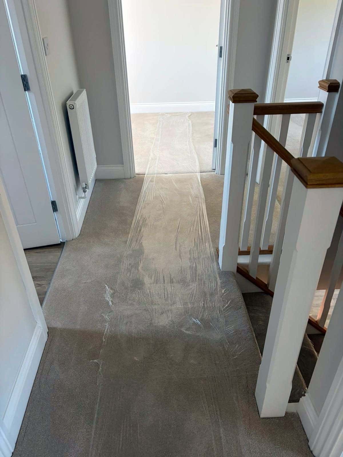 Upstairs landing carpet covered with protection film