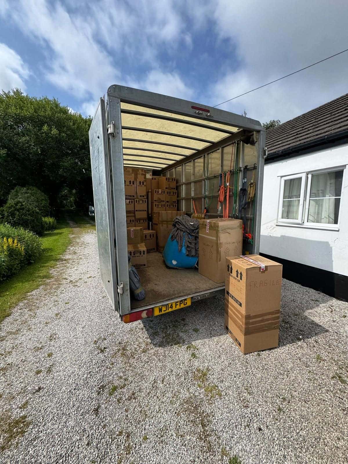 Open Duffield van with this-way-up cartons, blankets and straps, fragile carton outside