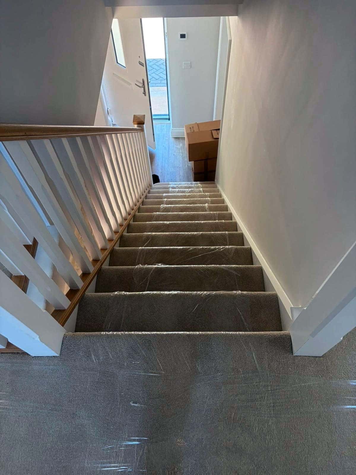 Stairs and landing covered in clear carpet protection film