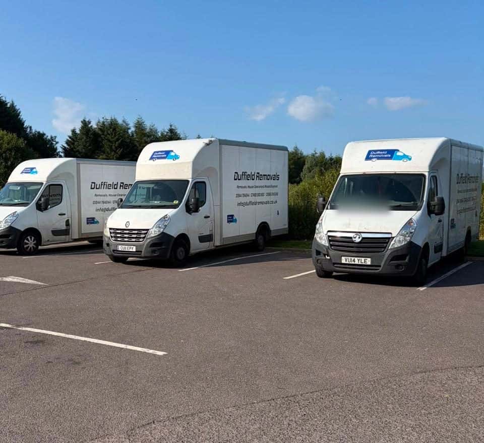Three Duffield Removals Luton vans lined up in a car park