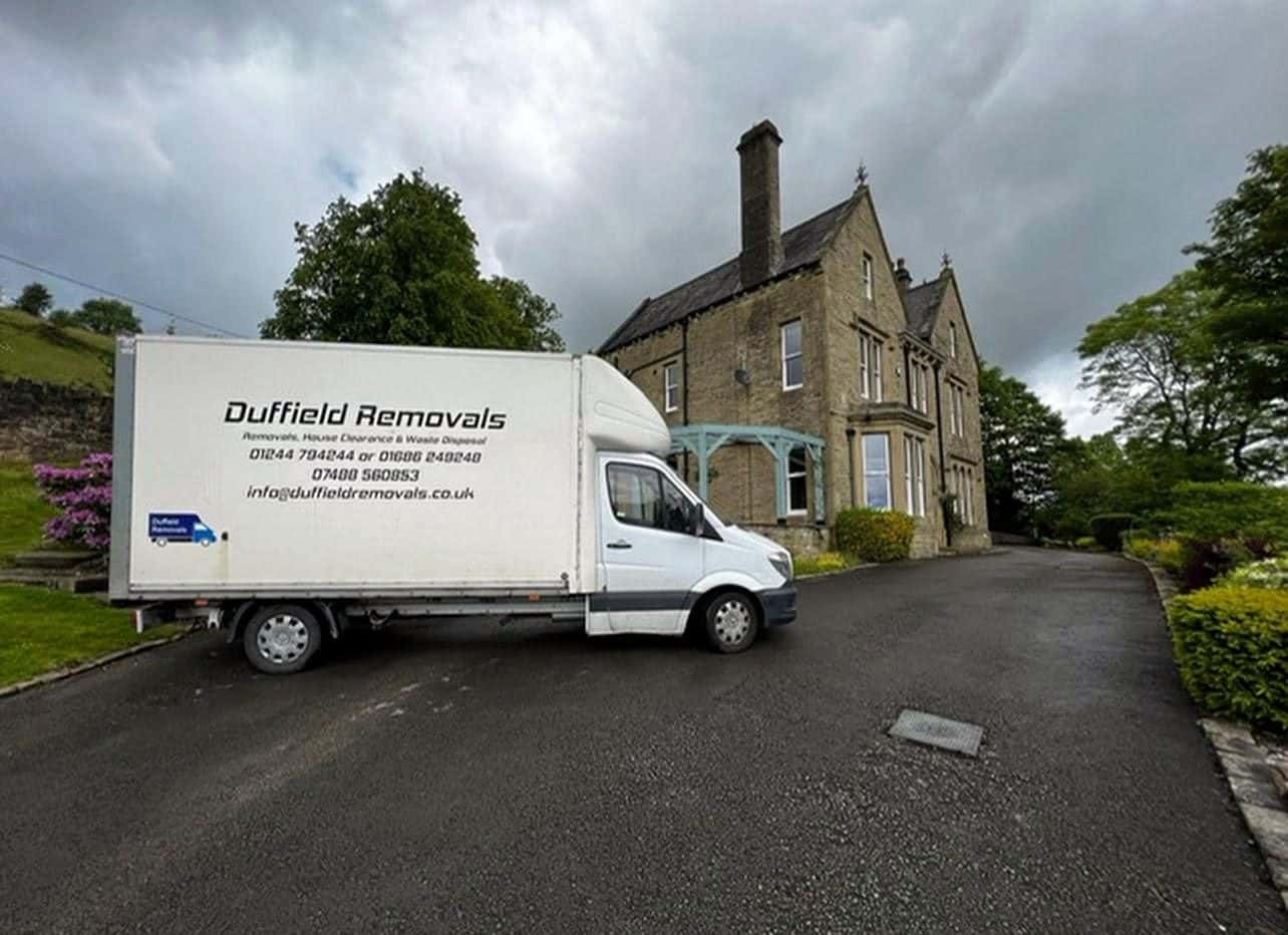 Duffield Luton van on the drive of a large Victorian stone house