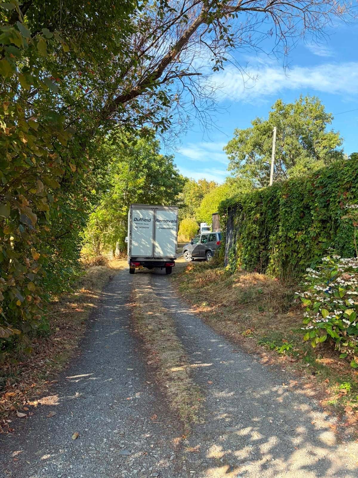 Duffield van driving up an unmade farm track between hedges