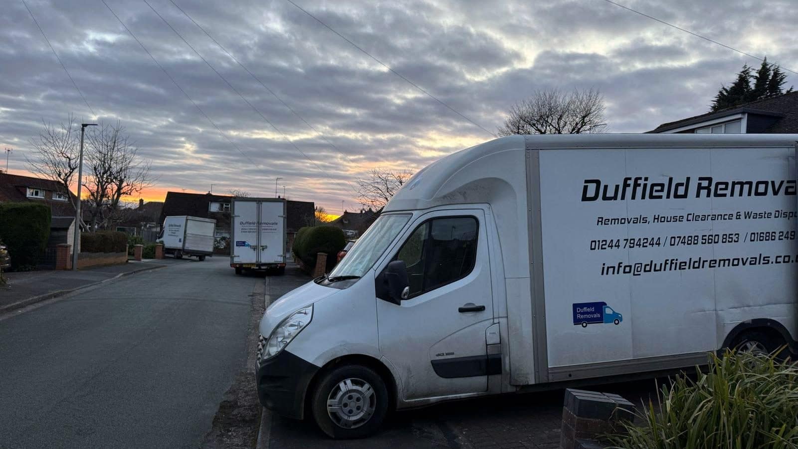 Duffield Removals vans on a residential street at sunrise for an early start