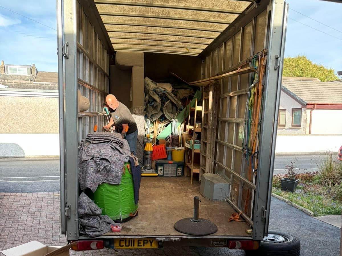 Duffield crew member loading a Luton van from a garage during a clearance