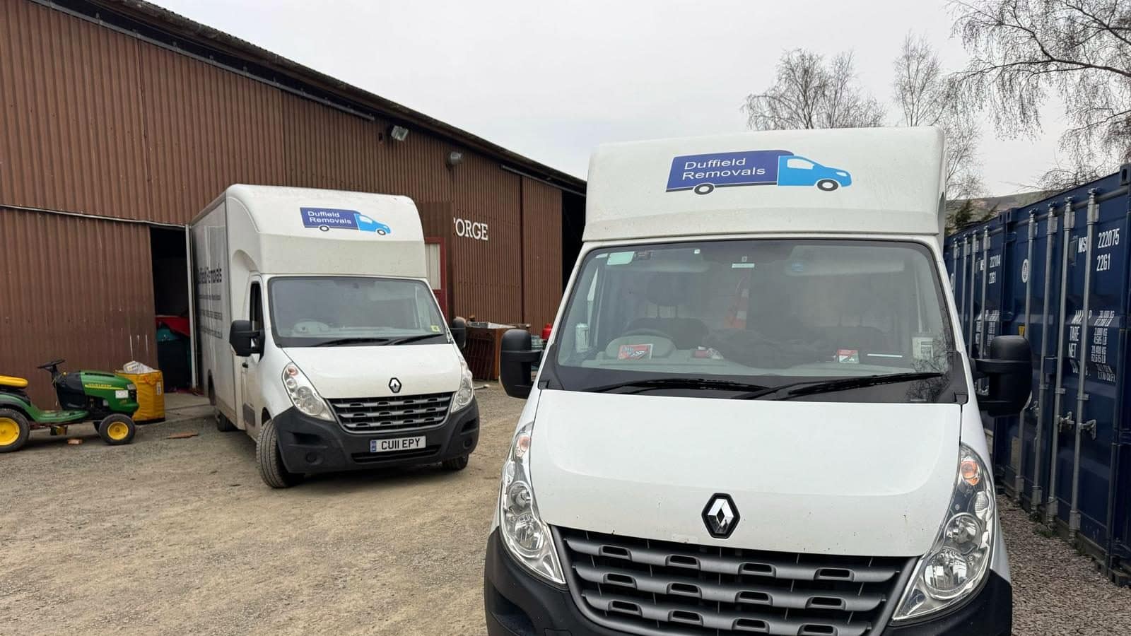 Duffield vans at the Rhayader storage yard beside our warehouse and blue containers